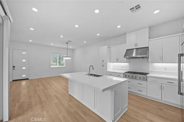 a kitchen with a stove a sink and a refrigerator