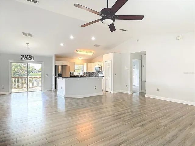 a view of a room with wooden floor