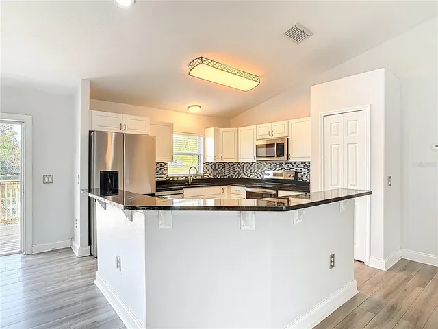 a view of a bathroom with a sink and a mirror