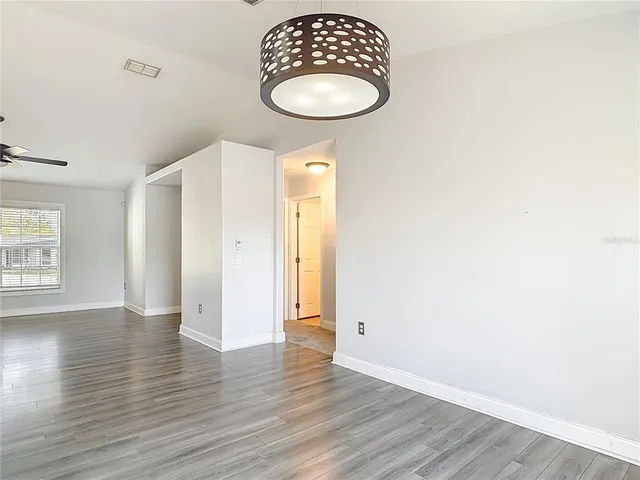 a kitchen with a refrigerator and a stove top oven