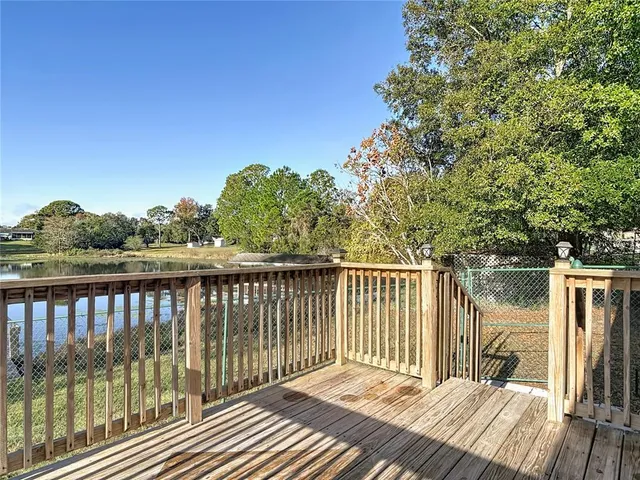 a view of a deck with chair and floor to ceiling window