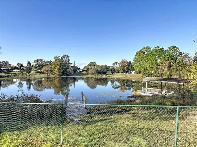 a view of a lake with houses in the back