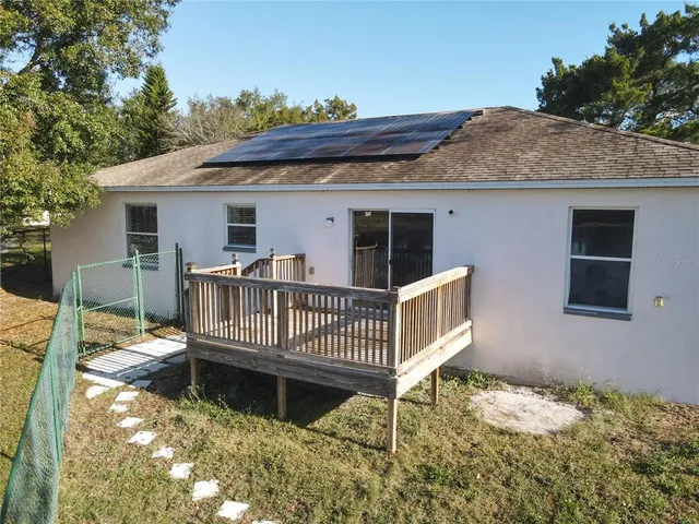 a view of a house with yard and sitting area