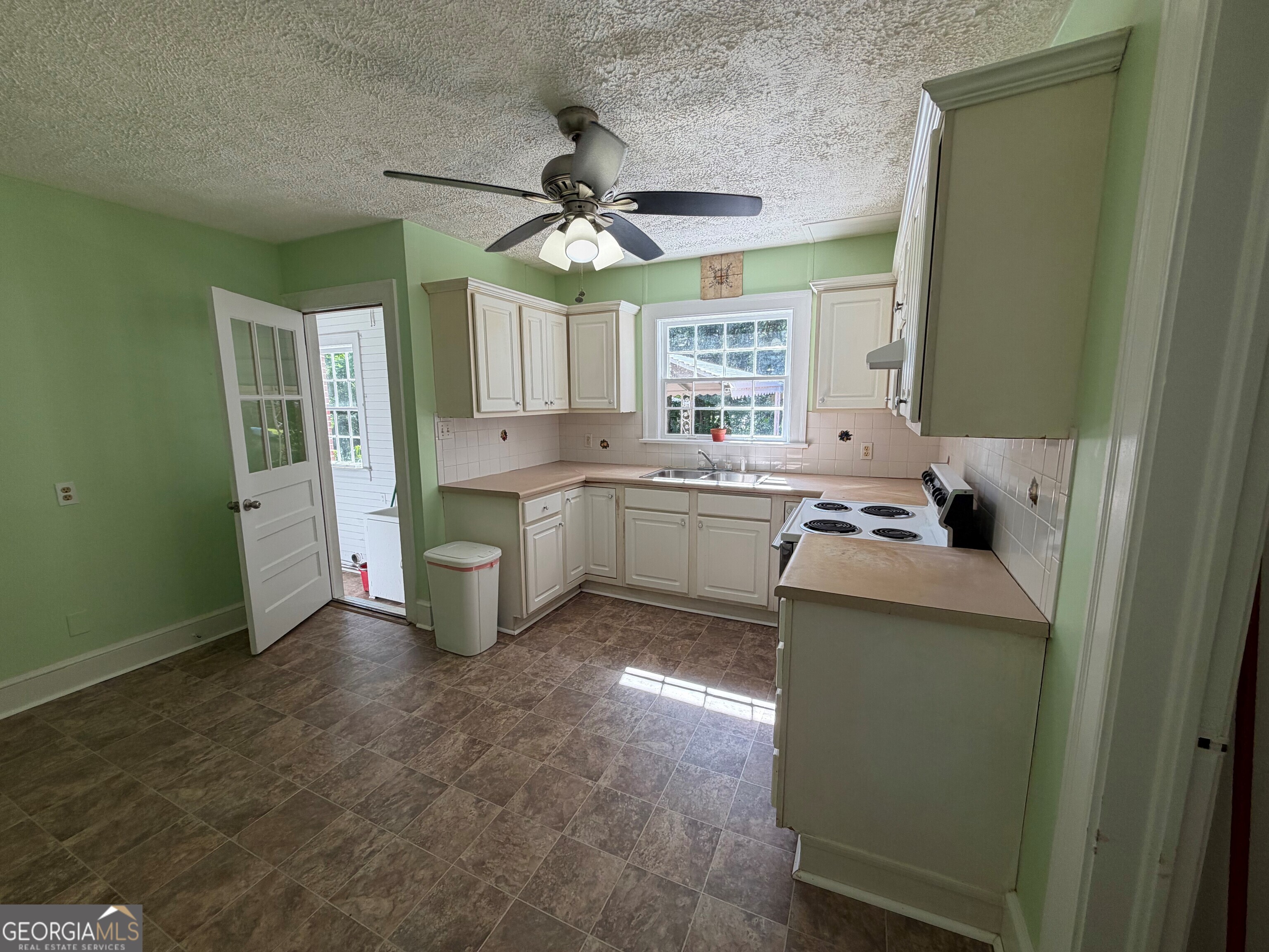 2619 Maple Road Southeast Rome, GA 30161 - Photo 8 of 31 a kitchen with a sink cabinets and window
