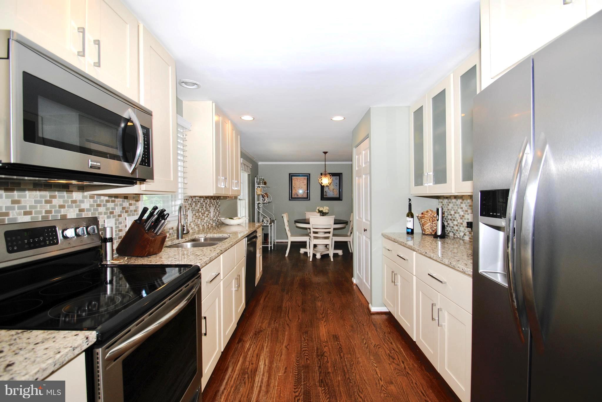 132 Church Road Arnold, MD 21012 - Photo 15 of 30 Sleek Granite and Stainless Galley-Style Kitchen