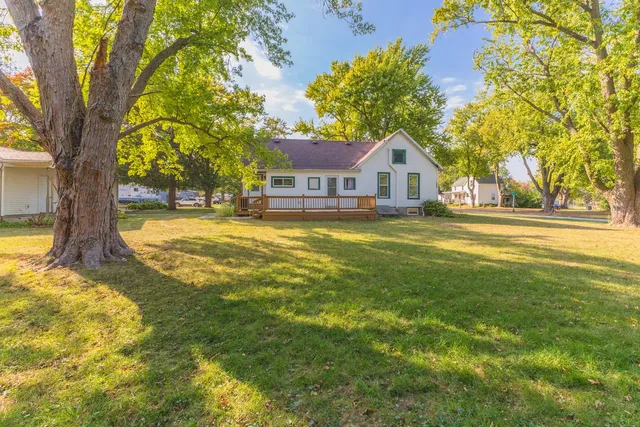 a house view with swimming pool in front of it