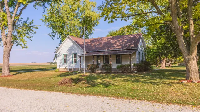 a view of a house with a tree in front of it