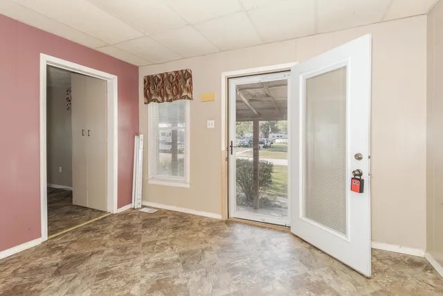 a view of a livingroom with a ceiling fan and window