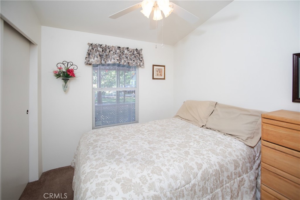 16390 Tish-A-Tang Road Lower Lake, CA 95457 - Photo 13 of 36 a bedroom with a bed and a chandelier