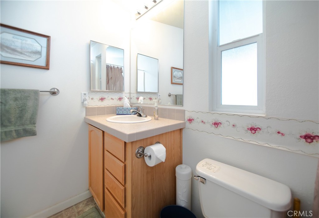 16390 Tish-A-Tang Road Lower Lake, CA 95457 - Photo 15 of 36 a bathroom with a sink mirror toilet and window