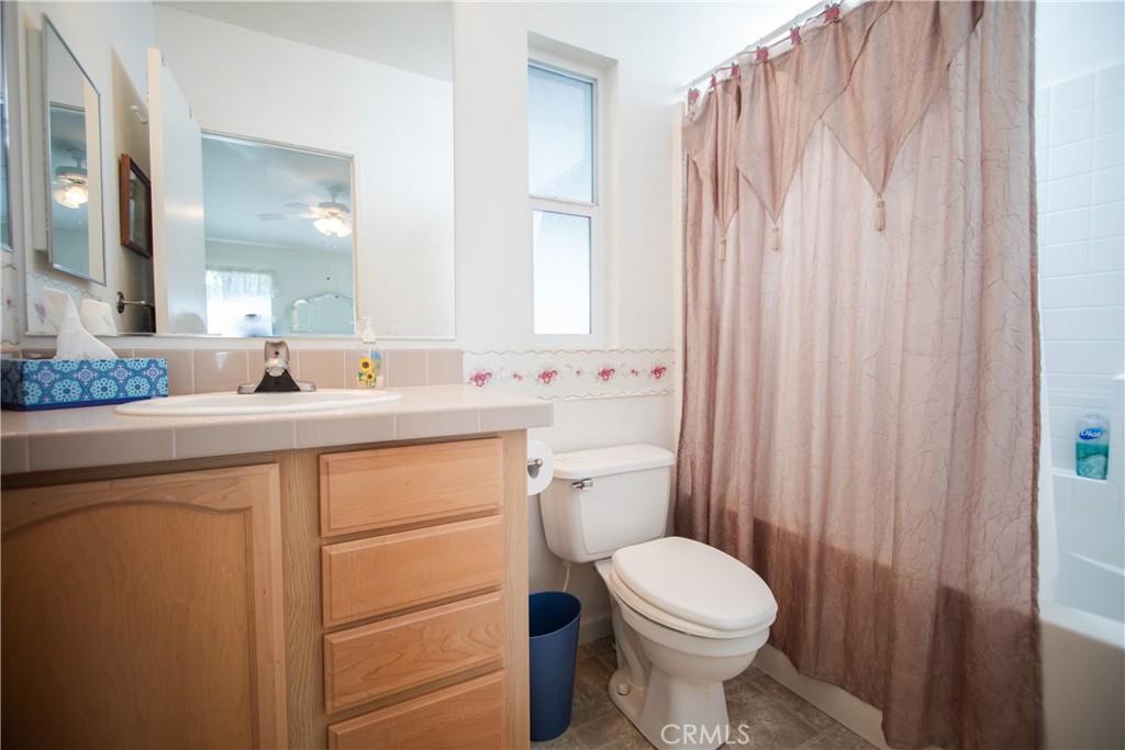 16390 Tish-A-Tang Road Lower Lake, CA 95457 - Photo 16 of 36 a bathroom with a sink a toilet and a mirror