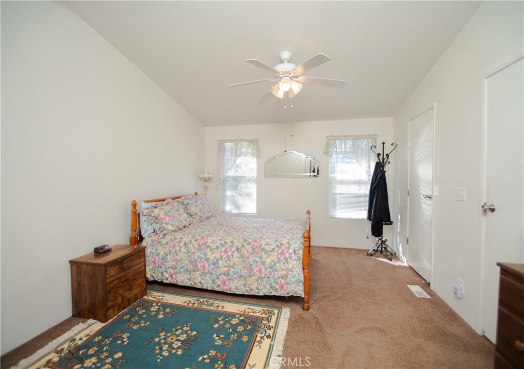 16390 Tish-A-Tang Road Lower Lake, CA 95457 - Photo 18 of 36 a bedroom with a bed and a chandelier