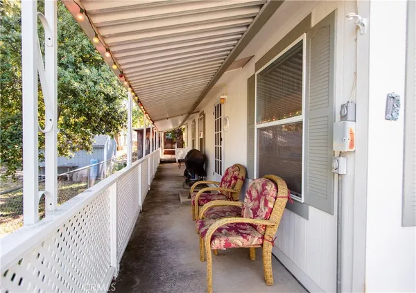 a balcony with furniture and a potted plant