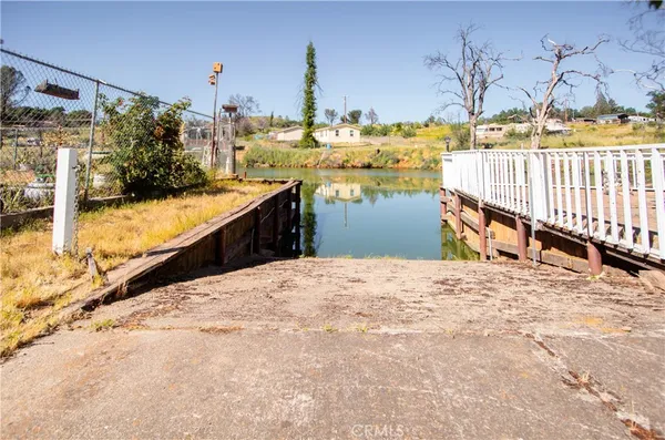 a large white kitchen with a lot of cabinets and outdoor space