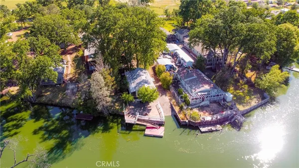 a view of a lake with couches and a table in a patio
