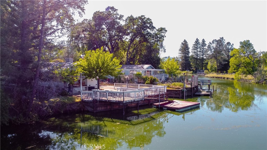 16390 Tish-A-Tang Road Lower Lake, CA 95457 - Photo 29 of 36 a view of a lake with couches and a table in a patio