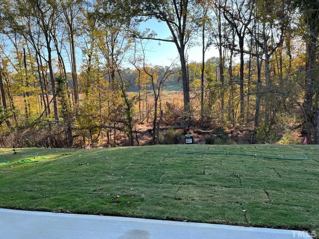 a view of yard with swimming pool and seating
