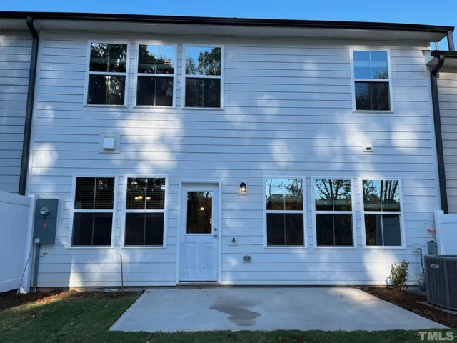 a view of a house with a swimming pool and sitting area