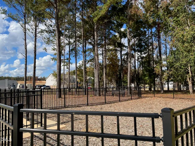 a view of a brick house with a small yard