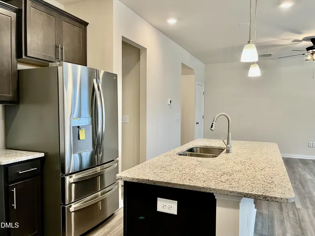 a kitchen with kitchen island a counter top space appliances and cabinets
