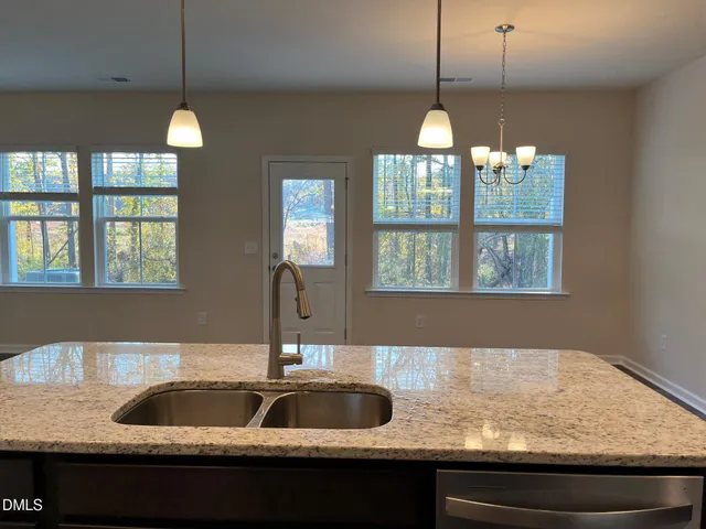a kitchen with granite countertop stainless steel appliances and cabinets