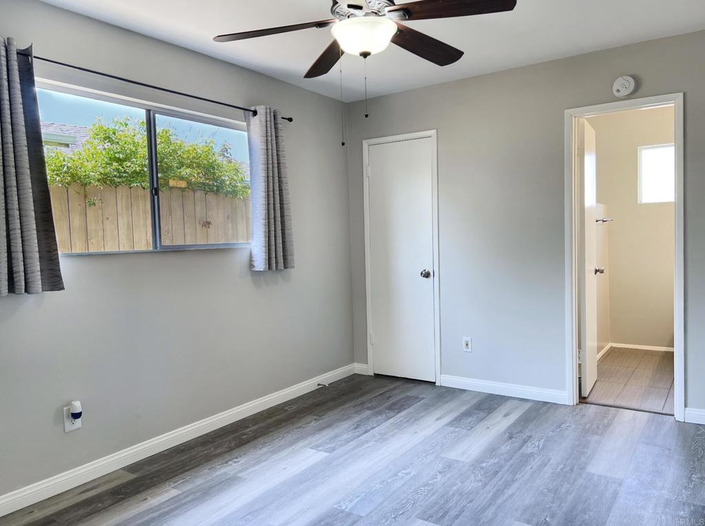 9038 Gorge Avenue Santee, CA 92071 - Photo 14 of 19 an empty room with wooden floor and windows