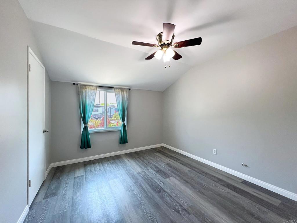 9038 Gorge Avenue Santee, CA 92071 - Photo 17 of 19 a view of empty room with wooden floor and fan