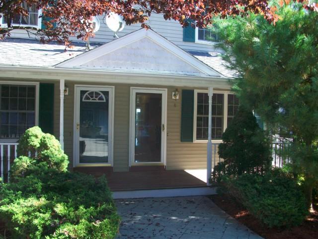 39 Coram Road, Unit 8 Shelton, CT 06484 - Photo 1 of 1 a front view of a house with garden