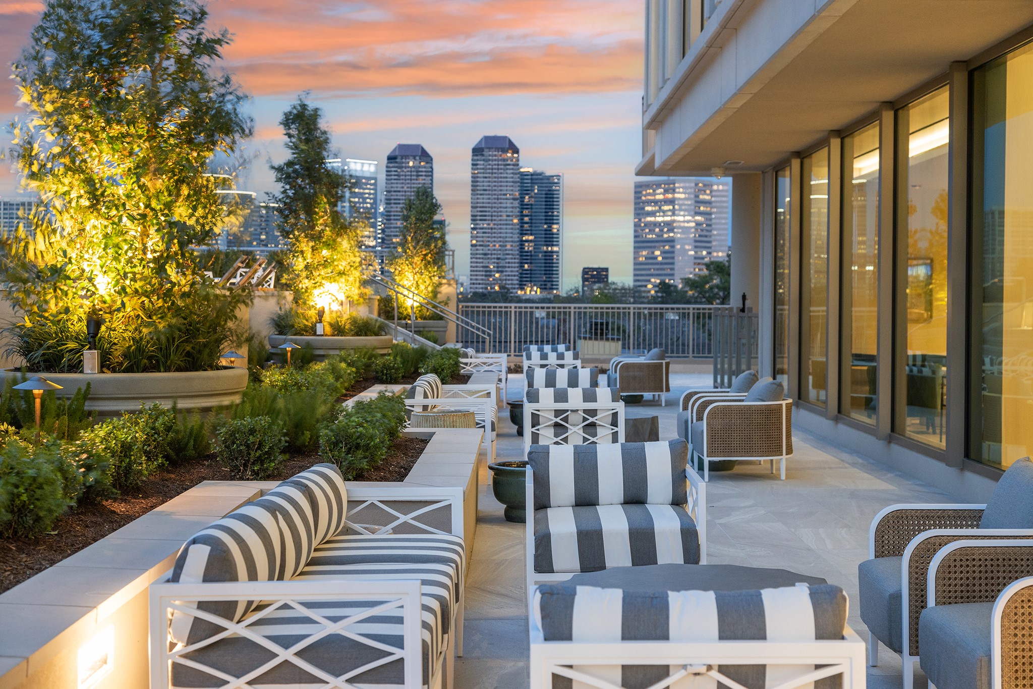 5656 San Felipe Street, Unit 1005 Houston, TX 77056 - Photo 29 of 33 Outdoor seating flanked by manicured landscaping welcomes you to take in dramatic views from Post Oak high-rises to dazzling sunsets.