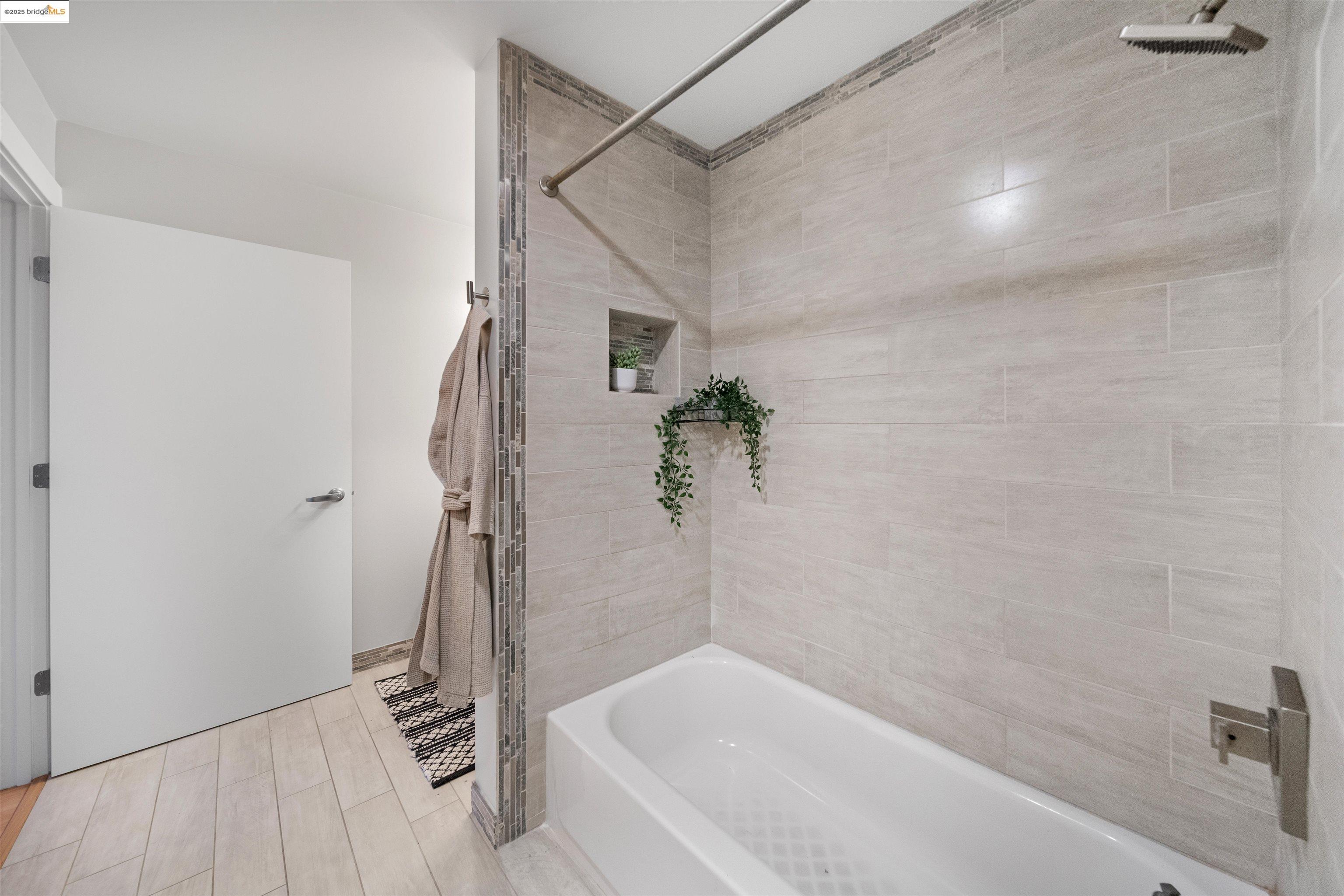 1201 Pine Street, Unit 363 Oakland, CA 94607 - Photo 13 of 25 a bathroom with a bathtub and shower