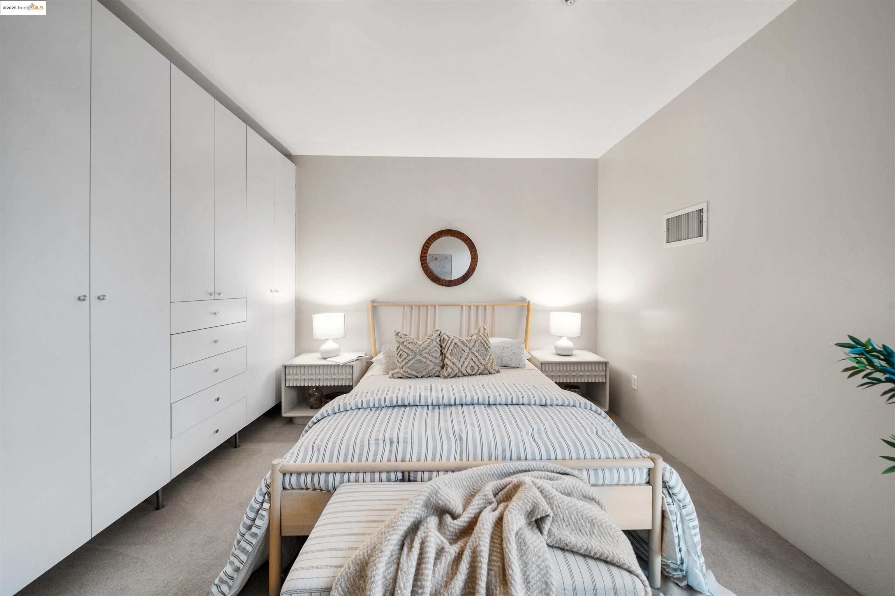 1201 Pine Street, Unit 363 Oakland, CA 94607 - Photo 24 of 25 a bedroom with a bed and a potted plant