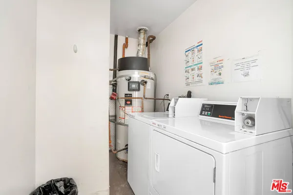 a kitchen with a sink a refrigerator and cabinets