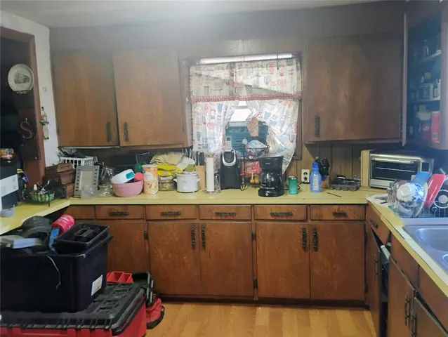 a kitchen with a sink cabinets and window