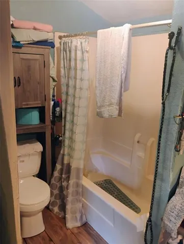 a bathroom with a toilet and a shower