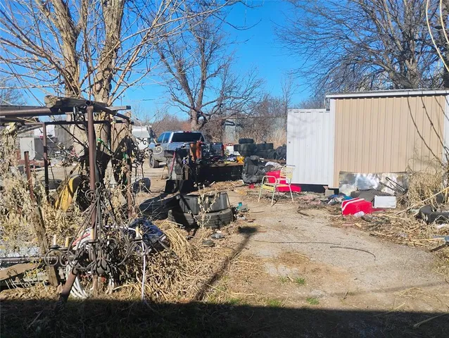 a view of backyard with table and chairs and a fire pit