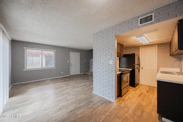 a kitchen with wooden cabinets stainless steel appliances and a sink