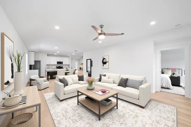 a living room with furniture a rug and a chandelier
