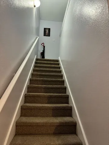 a view of a hallway with a chandelier fan