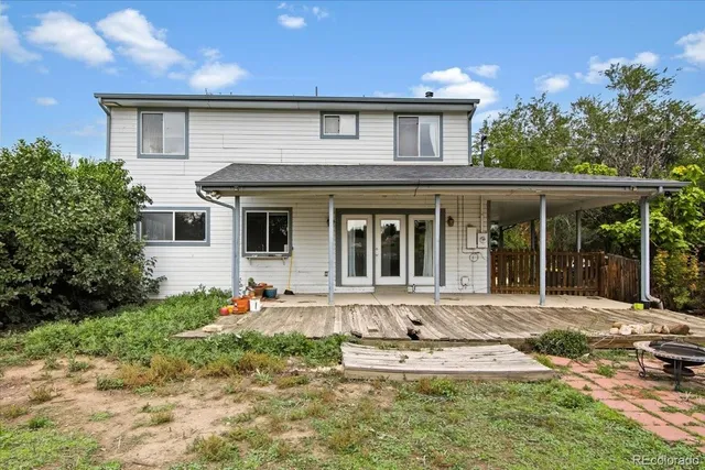 a front view of a house with a yard outdoor seating and garage