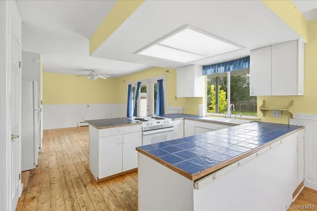 a kitchen with sink stove and refrigerator