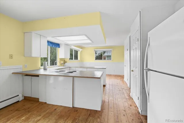 a kitchen with a sink stove and refrigerator