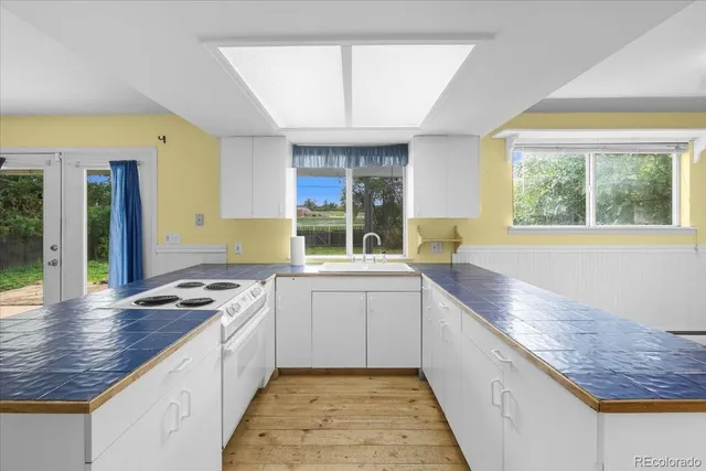 a kitchen with a sink stove and cabinets