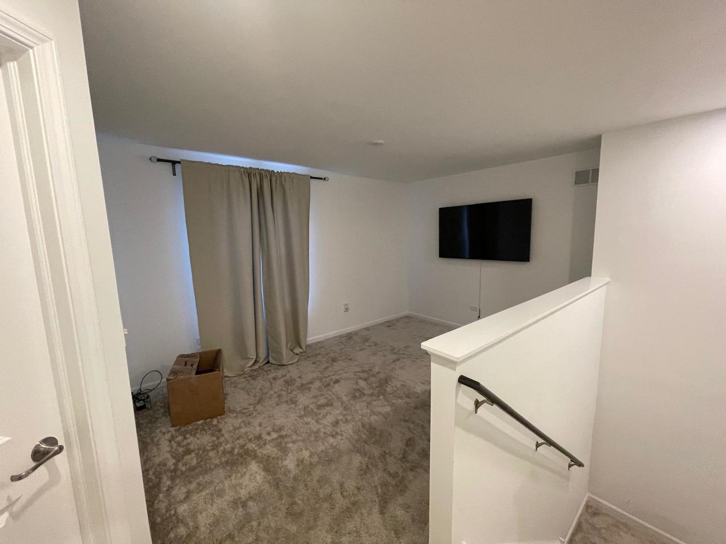 1464 Collins Street Elburn, IL 60119 - Photo 8 of 11 a view of a livingroom with an empty space and a hallway