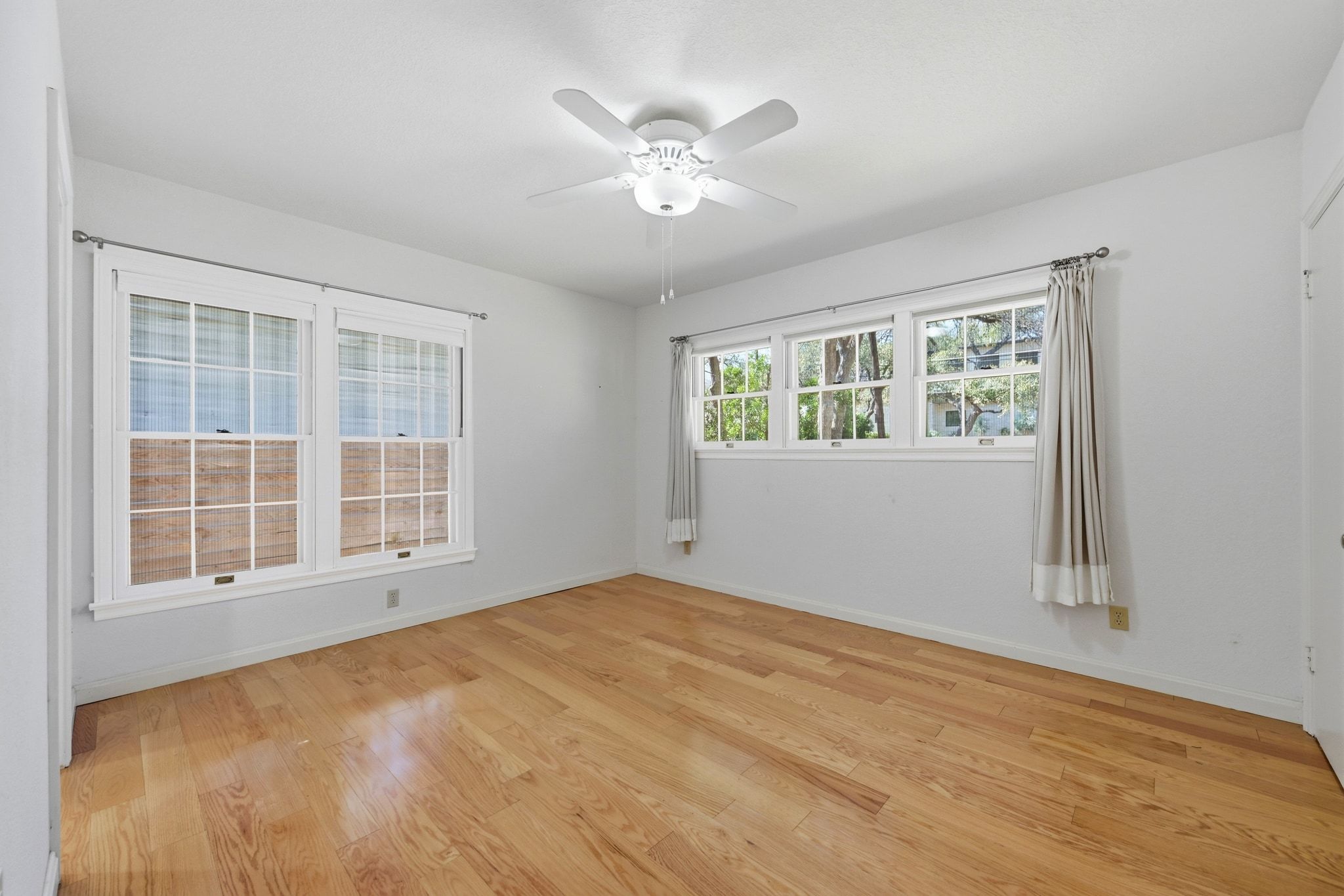 405 Ridgewood Road Austin, TX 78746 - Photo 14 of 32 The primary bedroom is filled with natural light.