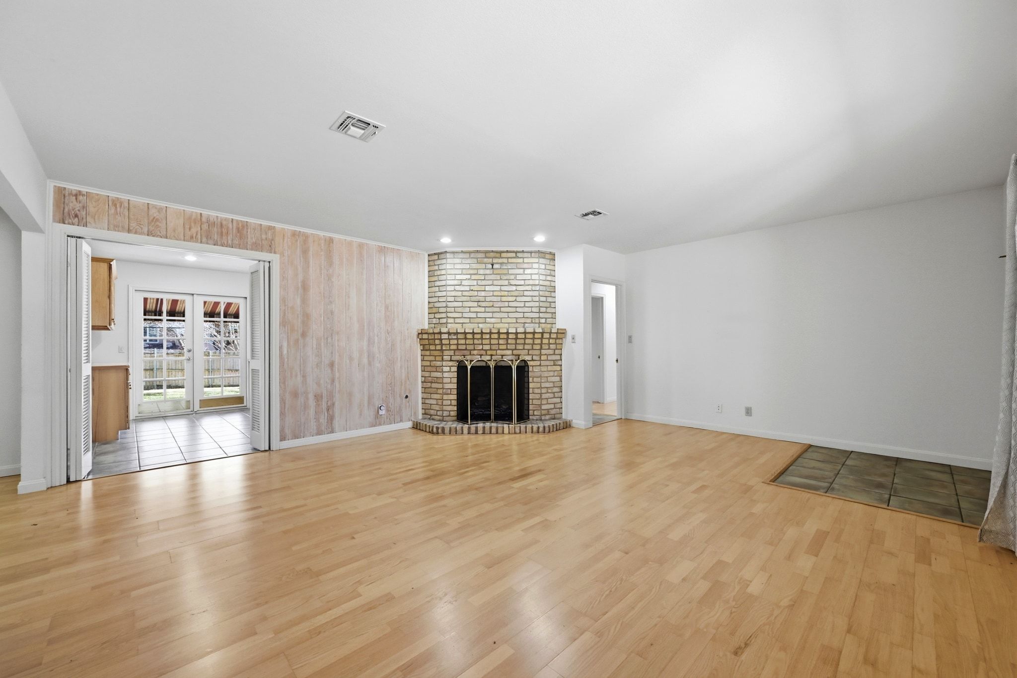 405 Ridgewood Road Austin, TX 78746 - Photo 6 of 32 The cozy brick fireplace is the centerpiece of the living room.