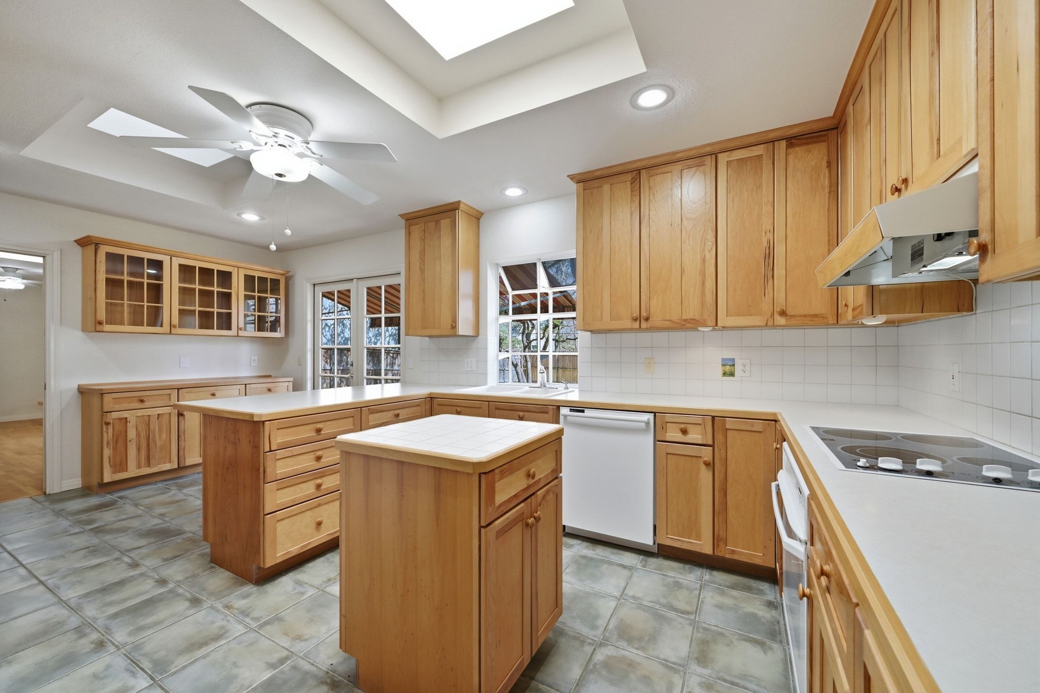 405 Ridgewood Road Austin, TX 78746 - Photo 7 of 32 The kitchen is bright and welcoming with abundant solid wood cabinetry.