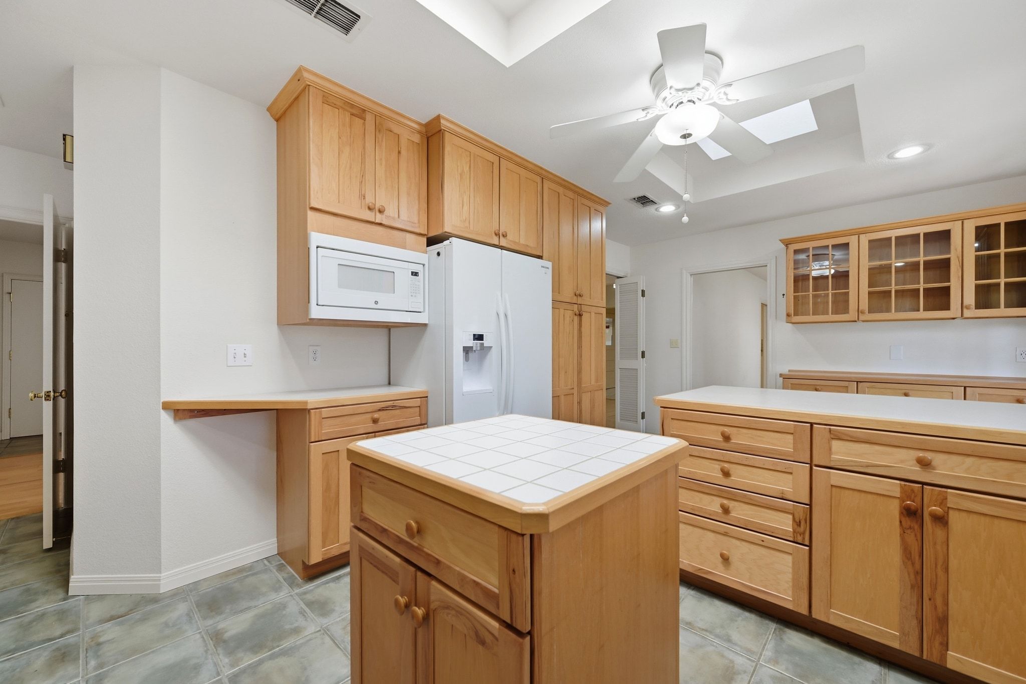 405 Ridgewood Road Austin, TX 78746 - Photo 8 of 32 A center island adds storage and prep space.