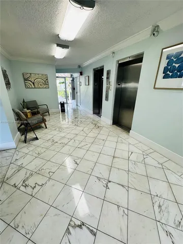 a living room with patio furniture and a table