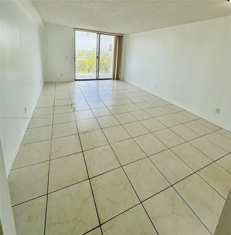 a view of an empty room and a window