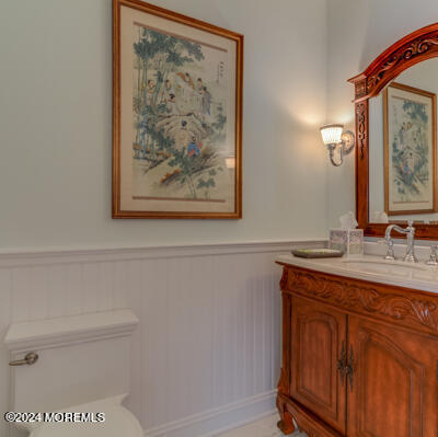 513 Mercer Avenue Spring Lake, NJ 07762 - Photo 33 of 53 a bathroom with a toilet a sink and a mirror